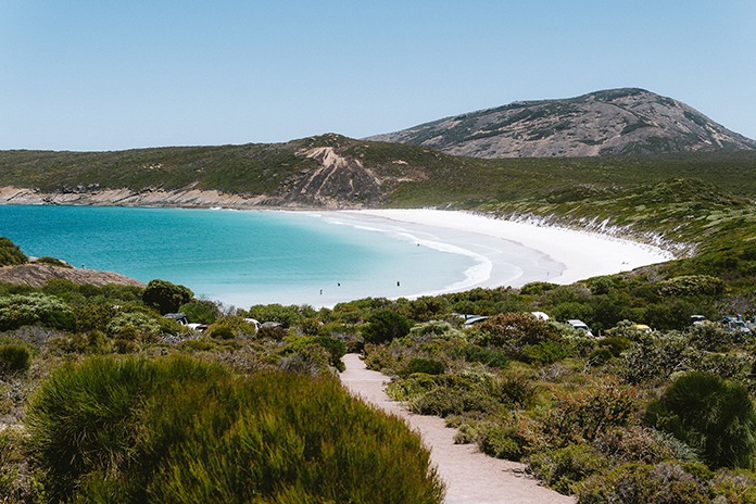 Picturesque coastal landscape at Lucky Bay with sweeping white sands and vibrant blue ocean views