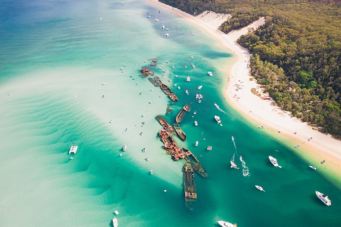 Aerial view of Moreton Bay's Tangalooma Wrecks surrounded by blue waters and sandy beaches